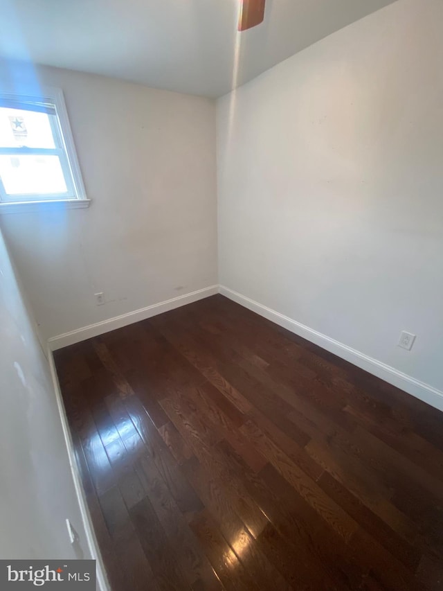 unfurnished room with dark hardwood / wood-style floors