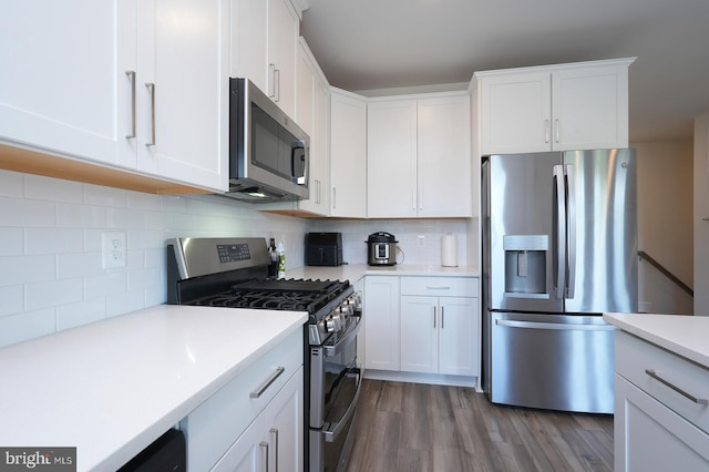 kitchen with stainless steel appliances and white cabinetry