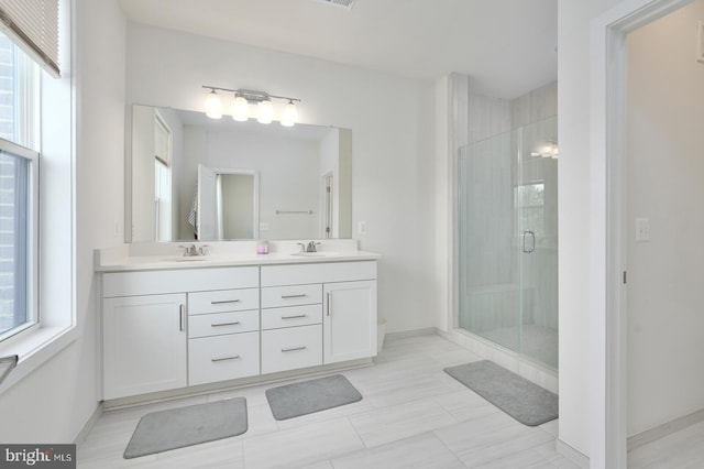 bathroom featuring vanity and a shower with shower door