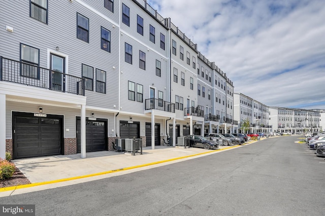 view of building exterior featuring cooling unit and a garage