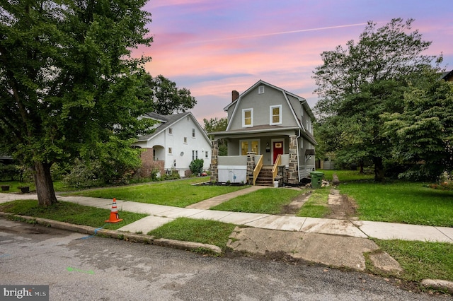 view of front of home featuring a yard and covered porch