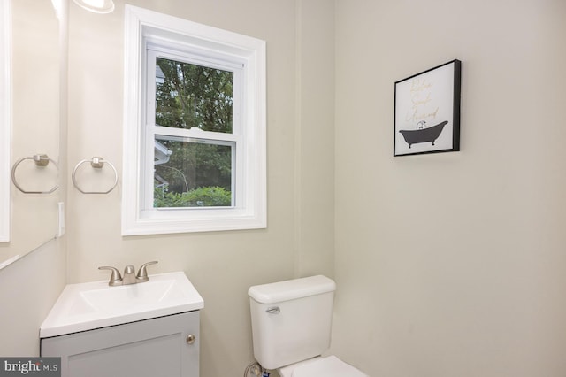 bathroom with vanity, toilet, and a healthy amount of sunlight