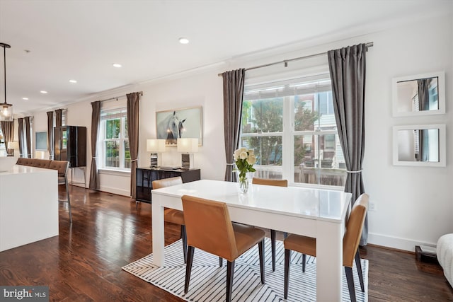 dining area with crown molding and dark hardwood / wood-style floors