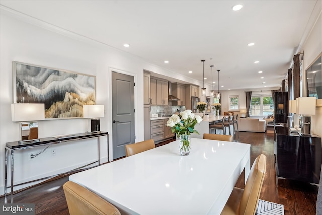 dining space featuring crown molding and dark hardwood / wood-style floors