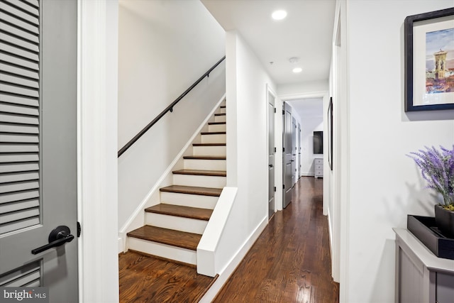 corridor with dark hardwood / wood-style flooring