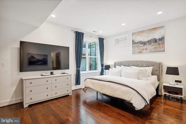 bedroom with dark hardwood / wood-style flooring