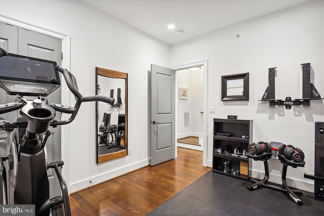 workout room featuring dark wood-type flooring