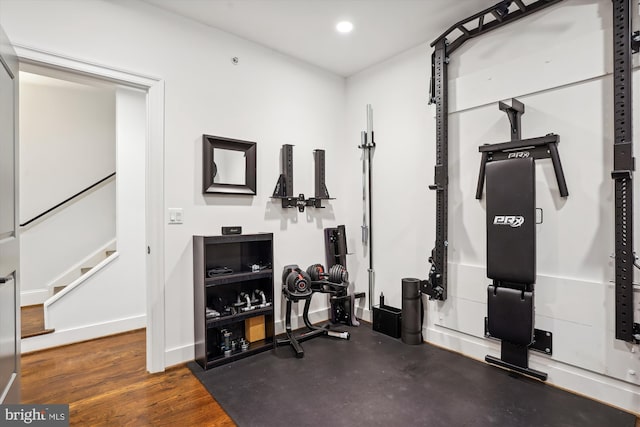 workout area with dark hardwood / wood-style floors