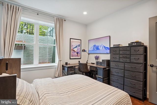 bedroom with dark hardwood / wood-style floors