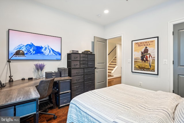 bedroom with dark hardwood / wood-style floors