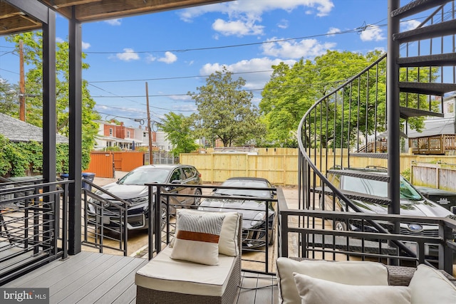 wooden terrace with an outdoor living space