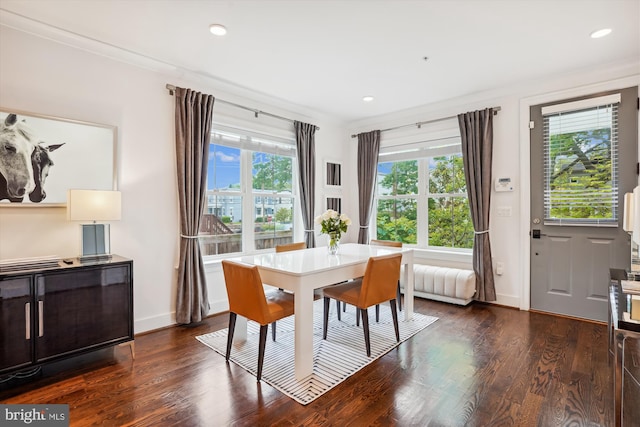 dining space with plenty of natural light, dark hardwood / wood-style floors, and ornamental molding