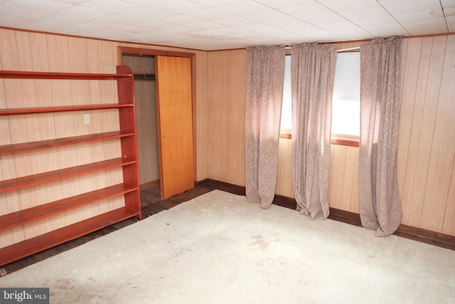 interior space featuring wood walls and baseboards