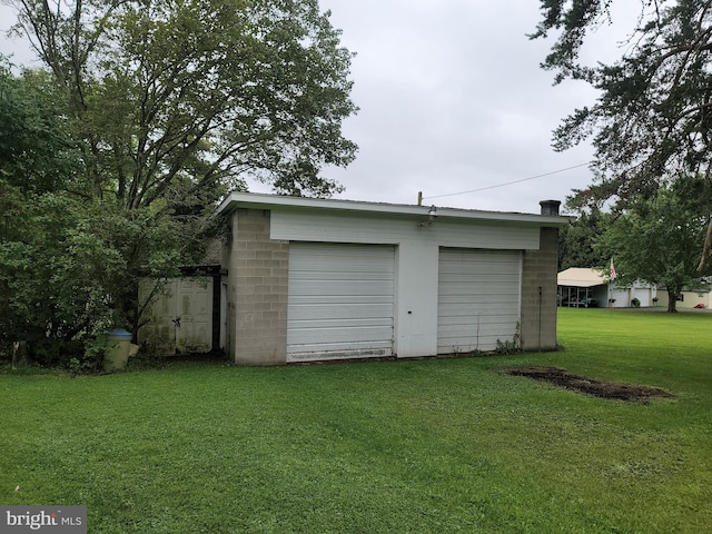 garage featuring a yard