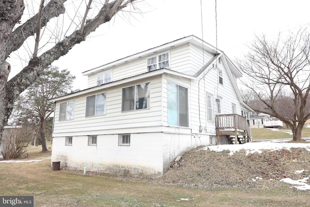 view of side of property with a yard