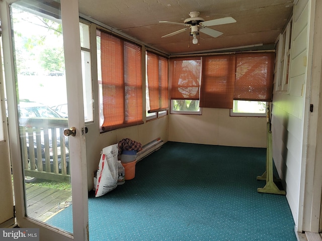 unfurnished sunroom with ceiling fan and plenty of natural light