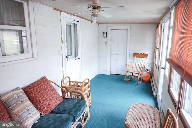 sunroom featuring a ceiling fan