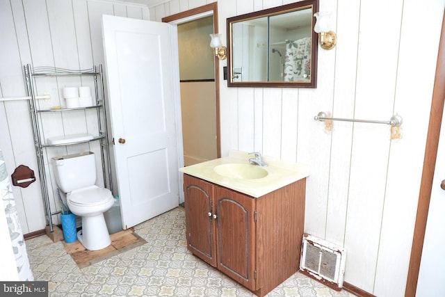 bathroom with toilet, vanity, and visible vents