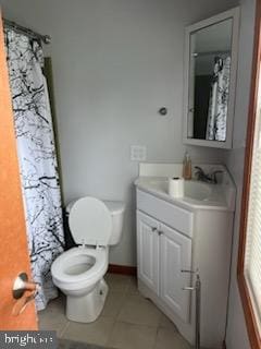 bathroom with vanity, toilet, and tile patterned floors