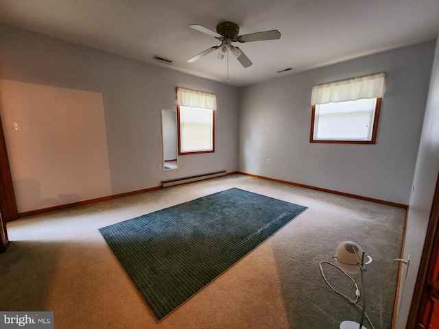 unfurnished room with plenty of natural light, ceiling fan, a baseboard radiator, and light colored carpet