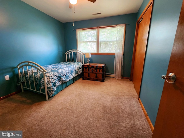 bedroom with a closet, ceiling fan, baseboard heating, and carpet floors