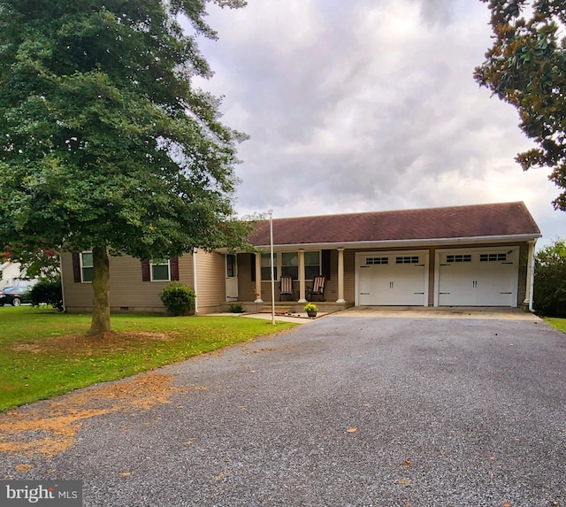 single story home featuring a garage and a front lawn