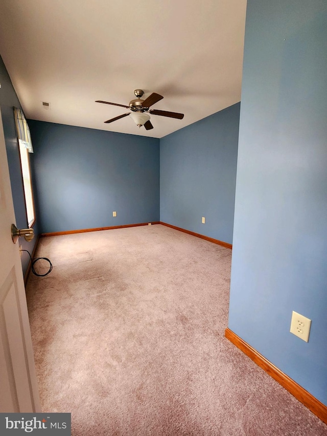 unfurnished room featuring ceiling fan and carpet floors