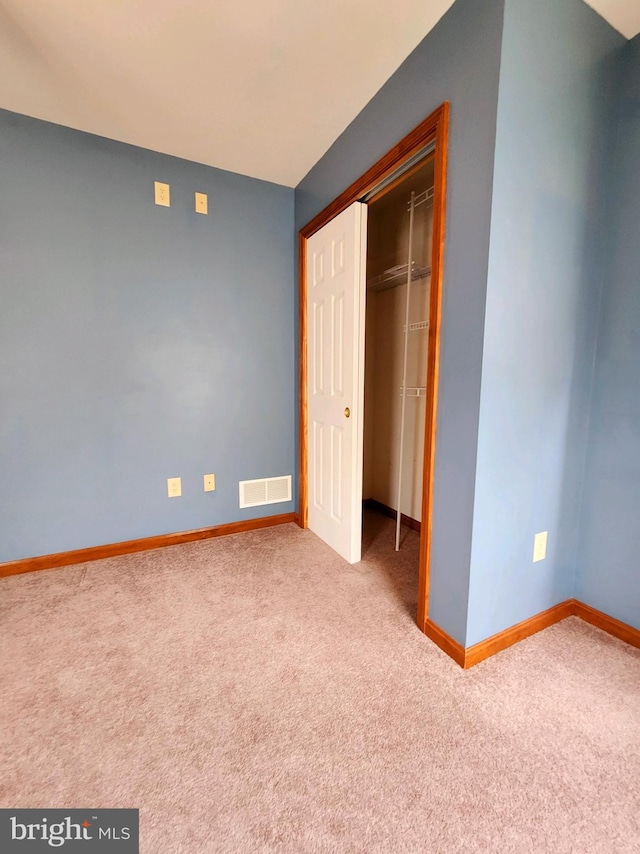 unfurnished bedroom featuring a closet and carpet flooring