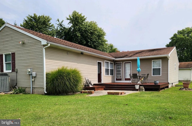 rear view of house with a yard, central AC, and a deck