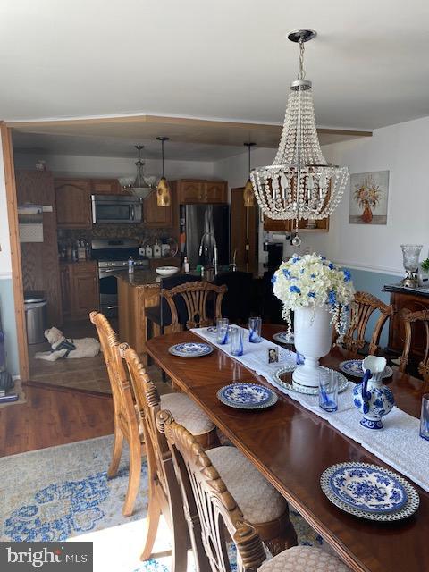 dining room with a notable chandelier and hardwood / wood-style flooring