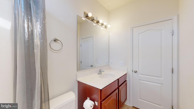 bathroom with toilet and vanity