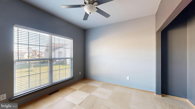 unfurnished room featuring a ceiling fan and visible vents