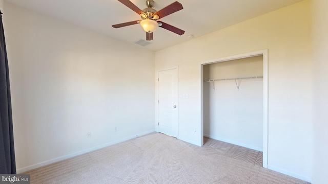 unfurnished bedroom with a closet, visible vents, a ceiling fan, carpet flooring, and baseboards