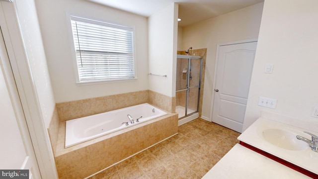 bathroom featuring a sink, a shower stall, and a tub with jets