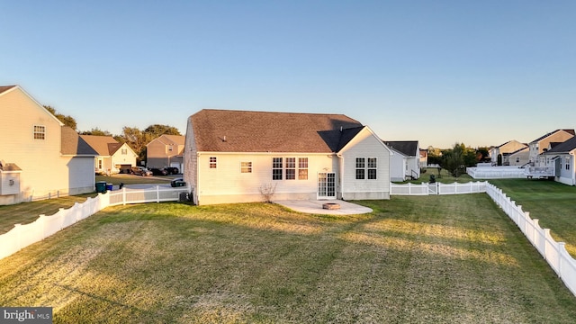 back of property with a fenced backyard, a residential view, a patio, and a yard