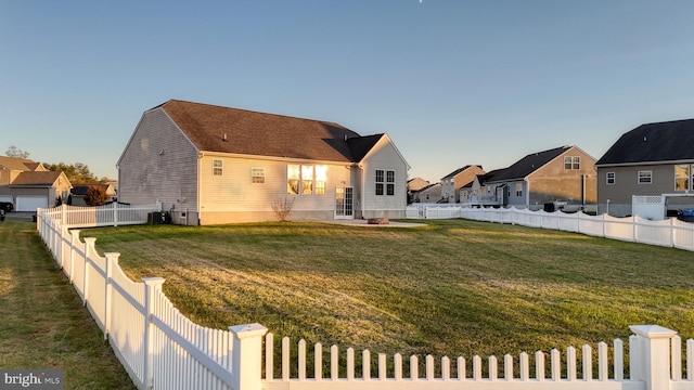 view of front of property with a fenced backyard, a residential view, a front lawn, and cooling unit