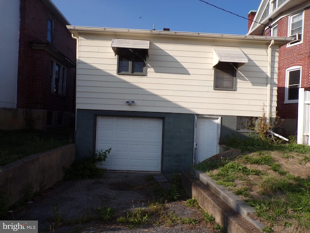 view of side of home featuring an attached garage