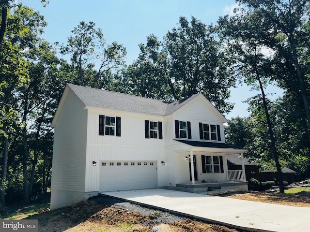 front of property featuring a porch and a garage