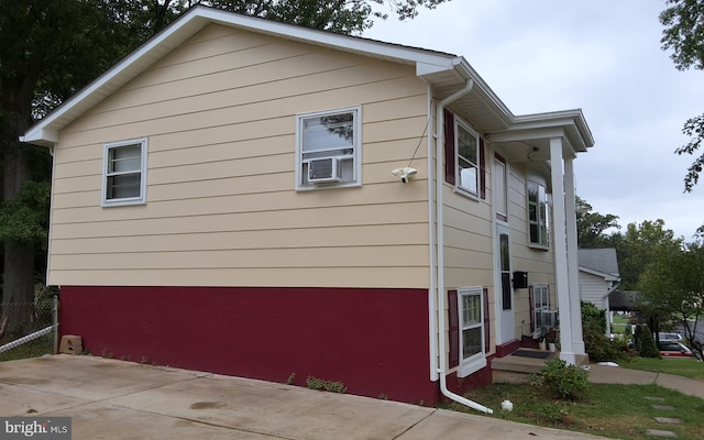 view of side of home featuring cooling unit