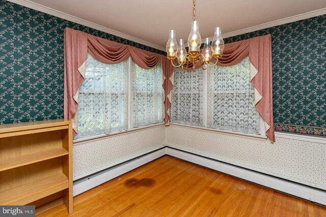 dining room featuring crown molding, a baseboard radiator, an inviting chandelier, and wood-type flooring