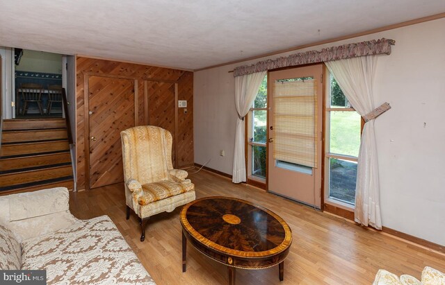 sitting room featuring ornamental molding and hardwood / wood-style floors