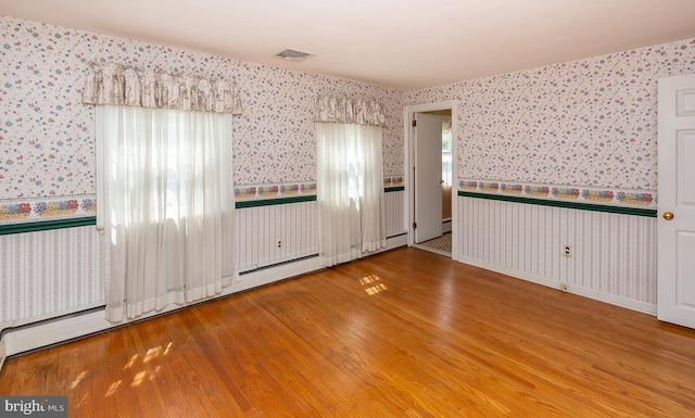 spare room with wood-type flooring