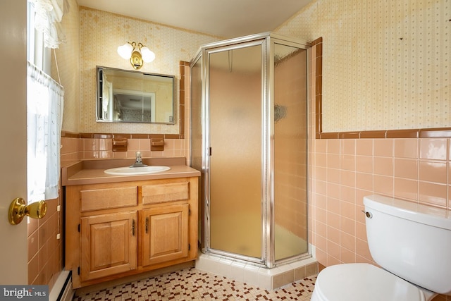 bathroom featuring vanity, an enclosed shower, tile walls, toilet, and tile patterned floors