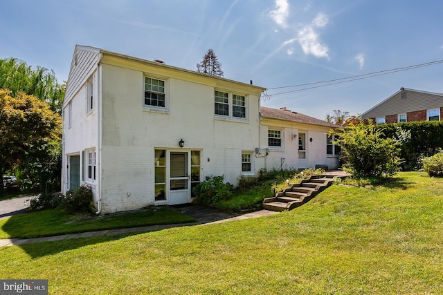 rear view of house with a yard