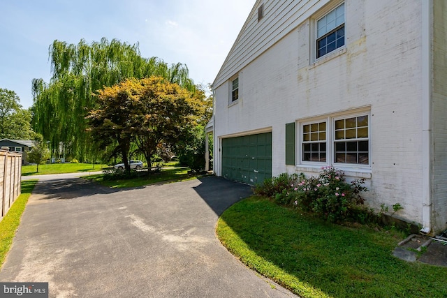 view of home's exterior featuring a yard and a garage