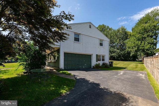 view of side of property with a yard and a garage