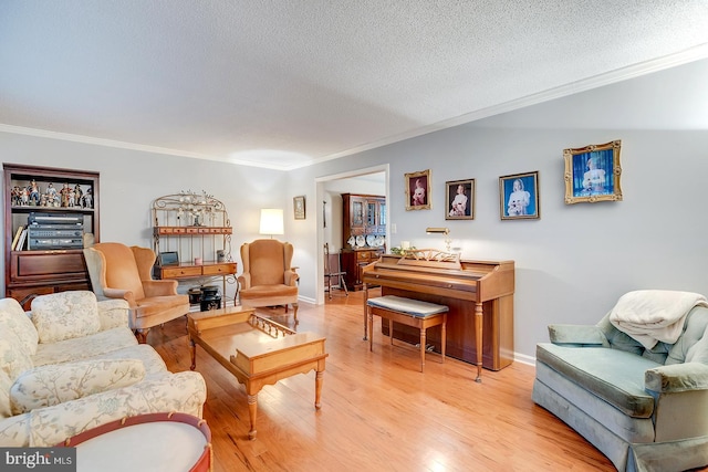 living room featuring a textured ceiling, light hardwood / wood-style flooring, and crown molding