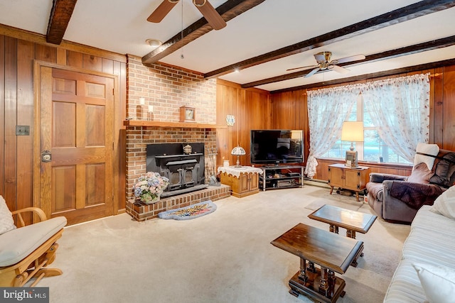 living room featuring a fireplace, wooden walls, ceiling fan, and beamed ceiling