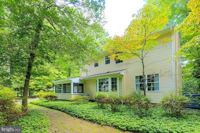 rear view of property with a sunroom