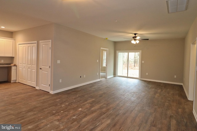 unfurnished living room with baseboards, visible vents, ceiling fan, dark wood-type flooring, and recessed lighting